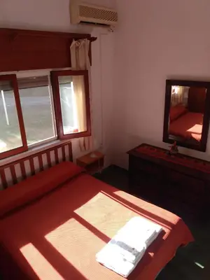 a bedroom with a large bed and a mirror at Villa Coca-Los Agapantos- in La Bolsa