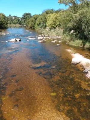 a river with rocks in the water at Villa Coca-Los Agapantos- in La Bolsa