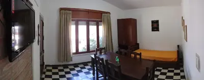a room with a table and a bed and a window at Villa Coca-Los Agapantos- in La Bolsa