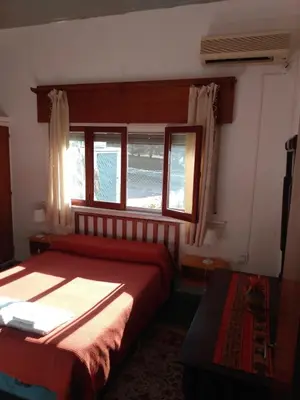 a bedroom with a bed and a window with the ocean at Villa Coca-Los Agapantos- in La Bolsa