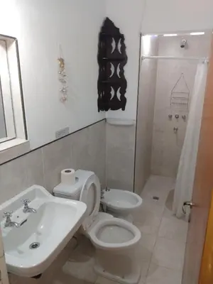 a bathroom with a toilet and a sink and a shower at Villa Coca-Los Agapantos- in La Bolsa