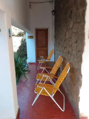 two yellow chairs and a table on a patio at Villa Coca-Los Agapantos- in La Bolsa