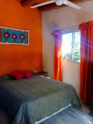 a bedroom with a bed and a window at MONOAMBIENTES LOS SAUCES in Mina Clavero