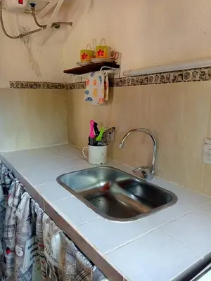 a kitchen counter with a sink in a kitchen at MONOAMBIENTES LOS SAUCES in Mina Clavero