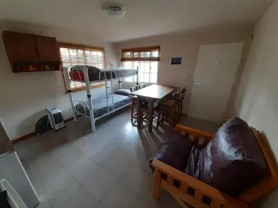 a room with a couch and a table and a bed at La Nubia Cabañas in Conlara
