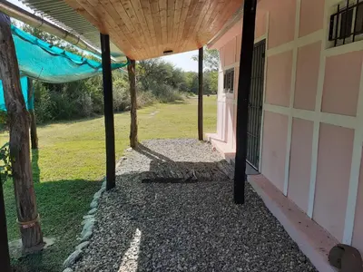 an outside view of a building with a porch at La Nubia Cabañas in Conlara