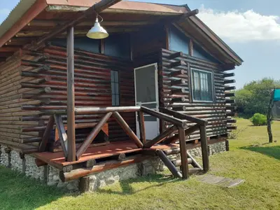 a log cabin with a porch and a door at La Nubia Cabañas in Conlara