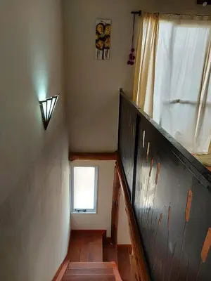 a staircase in a house with a window at Complejo SARA HOUSE in Santa Rosa de Calamuchita