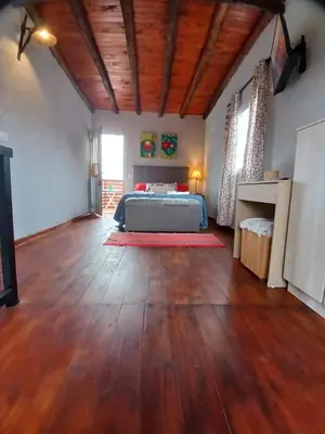a bedroom with a bed in the middle of a room at Complejo SARA HOUSE in Santa Rosa de Calamuchita