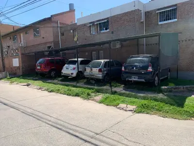 a group of cars parked in a parking lot at Cabañas San Gabriel Carlos Paz in Villa Carlos Paz