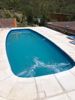 a large blue swimming pool on top of a house at Just Rest in Villa Serranita