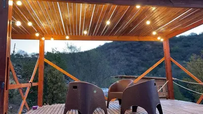 a patio with chairs and lights on a deck at Just Rest in Villa Serranita