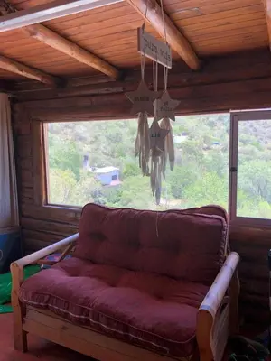 a couch in a room with a large window at Just Rest in Villa Serranita