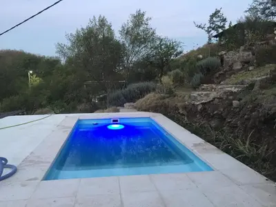 a small blue swimming pool on a patio at Cabañas Namaskar in Villa Serranita