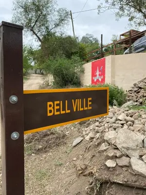 a sign that reads bell village on a road at Cabañas Namaskar in Villa Serranita