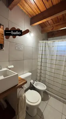 a bathroom with a toilet and a sink and a shower at Cabañas Sueño Dorado in Potrero de Garay