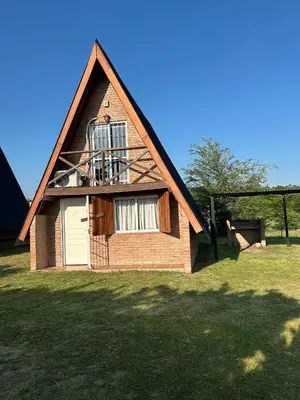 a small brick house with a window and a balcony at Cabañas Sueño Dorado in Potrero de Garay