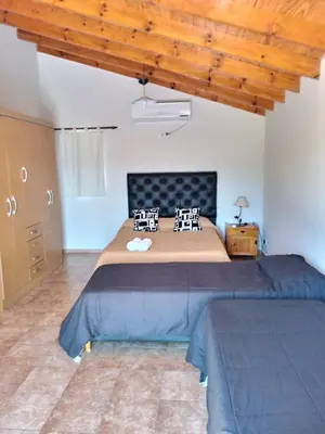 a bedroom with a large bed in a room at Duplex Alto El Espinillo in Villa General Belgrano
