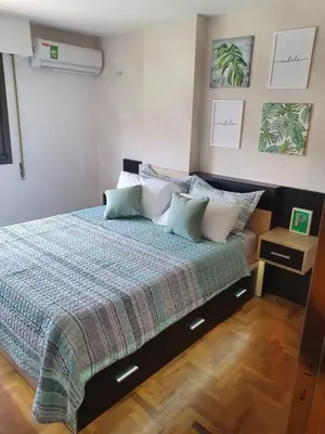 a bedroom with a bed with a blanket and pillows at Alojamiento Maria :-) in Cordoba
