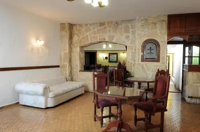 a living room with a couch and a table and chairs at Hotel Andino in Villa Carlos Paz