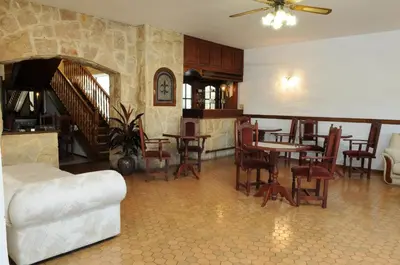 a living room with a table and a dining room at Hotel Andino in Villa Carlos Paz