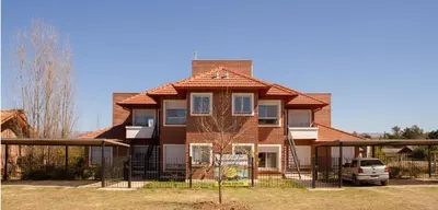 a house with a fence in front of it at Mirador Suite in Villa General Belgrano