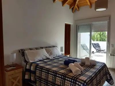 a bedroom with a bed with two towels on it at Mirador Suite in Villa General Belgrano
