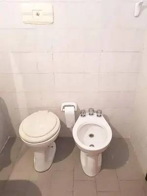 a bathroom with a toilet and a bidet at Dúplex frente al río en Playas de Oro in Villa Carlos Paz
