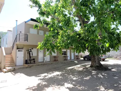 a house with a tree in front of it at DEPARTAMENTO MAGNET in Villa Carlos Paz