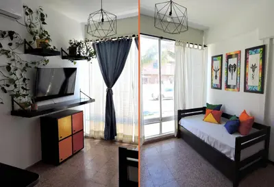 a bedroom with a bed and a tv and a window at DEPARTAMENTO MAGNET in Villa Carlos Paz