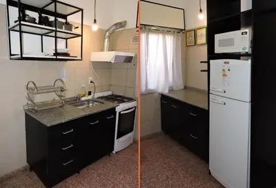 a small kitchen with a sink and a refrigerator at DEPARTAMENTO MAGNET in Villa Carlos Paz