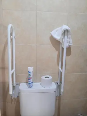a toilet with a roll of toilet paper on top of it at Alto Hermoso Apart in Cordoba