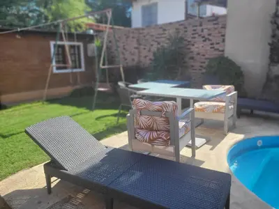 a patio with a table and chairs next to a pool at Alto Hermoso Apart in Cordoba