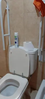 a bathroom with a toilet with a roll of toilet paper on it at Alto Hermoso Apart in Cordoba