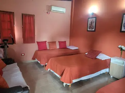 two beds in a room with red walls at Alto Hermoso Apart in Cordoba