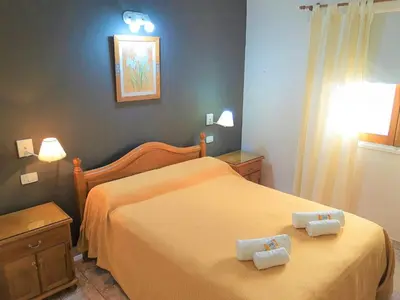 a bedroom with a bed with two towels on it at Hotel Brisas in Villa Carlos Paz