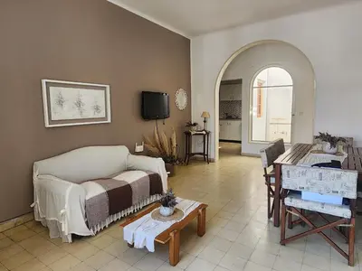 a living room with a couch and a table at Rivahome in Cordoba