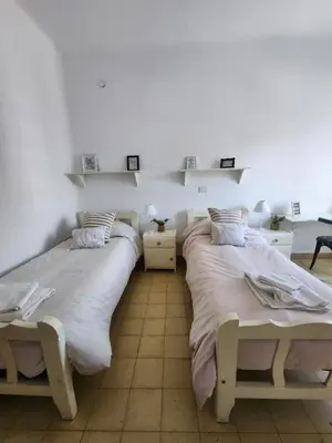 two beds sitting next to each other in a room at Rivahome in Cordoba