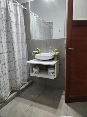 a bathroom with a sink and a shower curtain at Rivahome in Cordoba