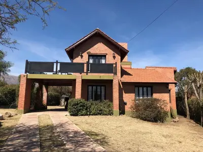 a brick house with a balcony on top of it at Chalet Individual Maiten 1 in Merlo