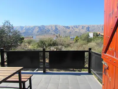 a balcony with a table and a view of the mountains at Chalet Individual Maiten 1 in Merlo