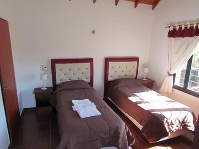 a bedroom with two beds and a window at Chalet Individual Maiten 1 in Merlo