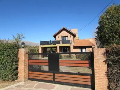 a gate to a house with a fence at Chalet Individual Maiten 1 in Merlo