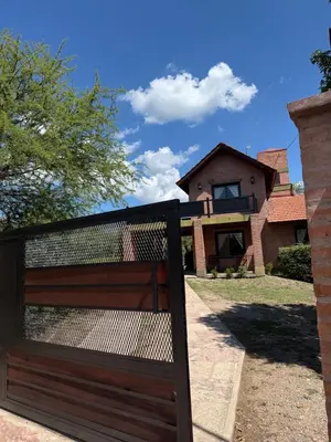 a wooden fence in front of a house at Chalet Individual Maiten 1 in Merlo