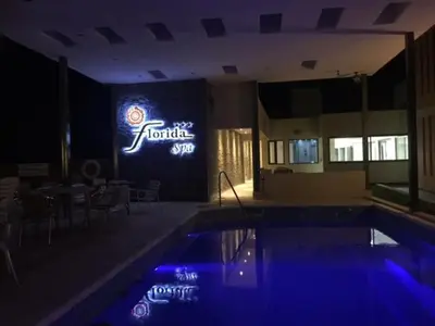 a swimming pool with a hotel sign in the background at Florida Hotel & Spa in Villa Carlos Paz