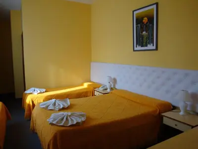 a hotel room with two beds with towels on them at Florida Hotel & Spa in Villa Carlos Paz