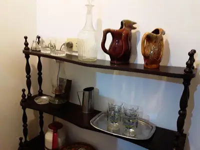 a shelf with bottles and glasses on it at Corro temporal in Cordoba