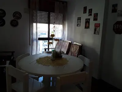 a dining room with a table and chairs and a window at Corro temporal in Cordoba