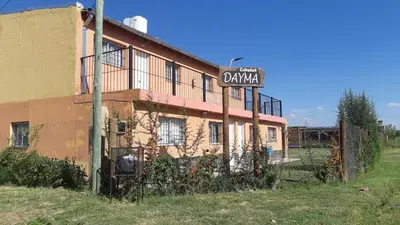 an old building with a street sign in front of it at Cabañas Dayma in Trapiche