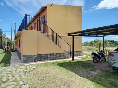 a motorcycle parked in front of a building at Cabañas Dayma in Trapiche